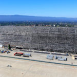 In March of 2022 Engineers were to undertake a massive restoration effort of this iconic landmark. After the remediation, clean-up, and restoration work is complete, Hangar One - now 90 years old - will be closer than ever to reuse. Hangar One measures approximately 1,133 feet long, 308 feet wide, and 198 feet high.
Years ago, the Navy removed all the hangar's roof, siding, windows, doors, and other materials, which were contaminated with toxic chemicals, specifically PCBs and asbestos. The Navy then sealed the hangar's structural frame with epoxy to ensure the chemicals would not pose a health risk, leaving it intact until further work could be completed.
Now the task of removing the remaining toxic chemicals from the hangar begins. First, working section by section, areas of Hangar One will be surrounded with scaffolding and encased to keep materials inside. Only then will the contaminated materials be carefully removed and stored in the vicinity of the hangar until they can be taken off-site for proper disposal. After the contaminated materials are removed, the steel frame will be primed and repainted to protect it from the elements until adding siding, windows, and doors can begin.
As each section is complete, several structural upgrades will also be made – to ensure the enormous hangar is seismically stable, for example – as well as other mechanical, plumbing, electric, landscape, and hardscape improvements. 
The cleaning, repainting, and upgrades to the entire hangar are scheduled to be completed by 2025. Once Hangar One is fully restored, engineers plan for it to resemble, as closely as possible, its original visual characteristics. 